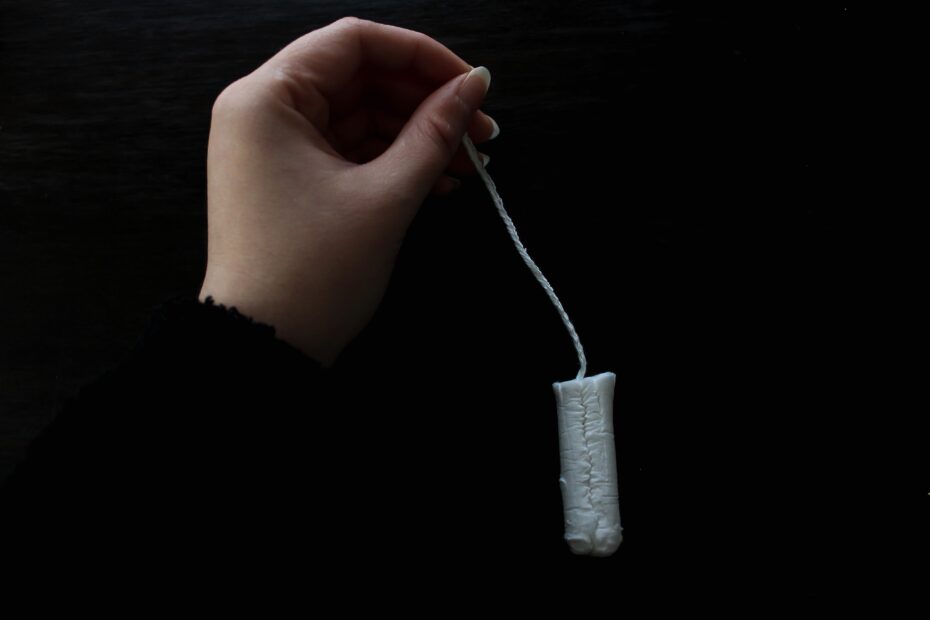 person holding white thread roll